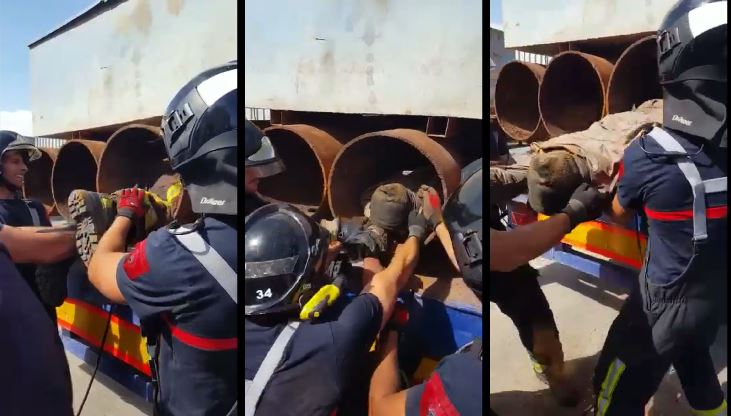Secuencia del rescate: Un bombero entra en el tubo para atar una cuerda al inmigrante y poder tirar de él hacia el exterior