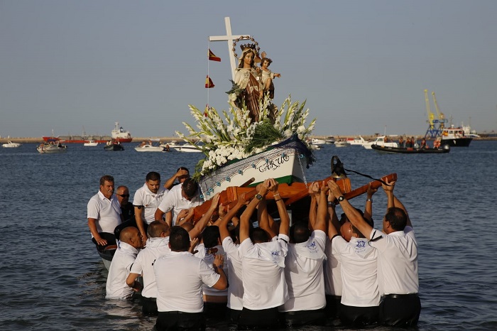 La difícil subida de la Virgen a la barca para el paseo por la dársena