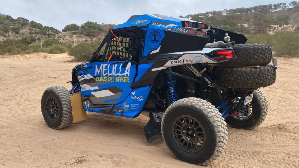 Vehículo de competición con colores de Melilla en un entorno natural