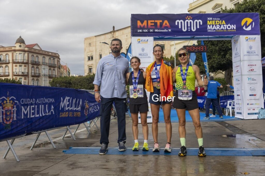 Reyes Estévez y ganadoras de la Media Maratón de Melilla posando en la meta.