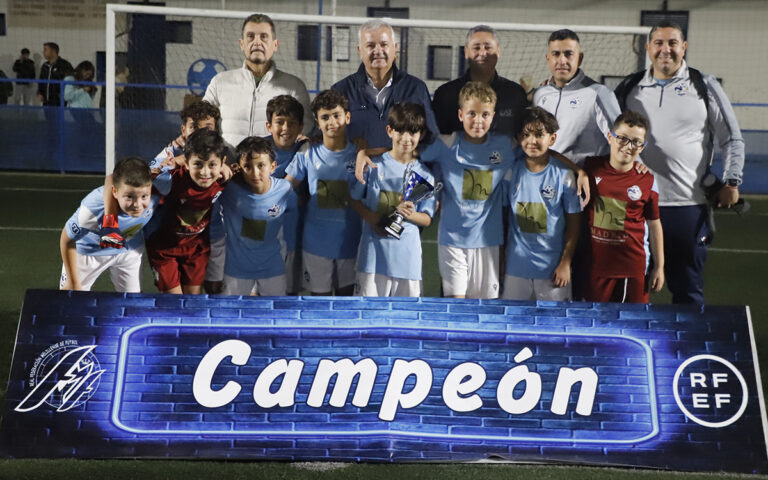 Equipo Melilla City posando con trofeo en el campo de fútbol