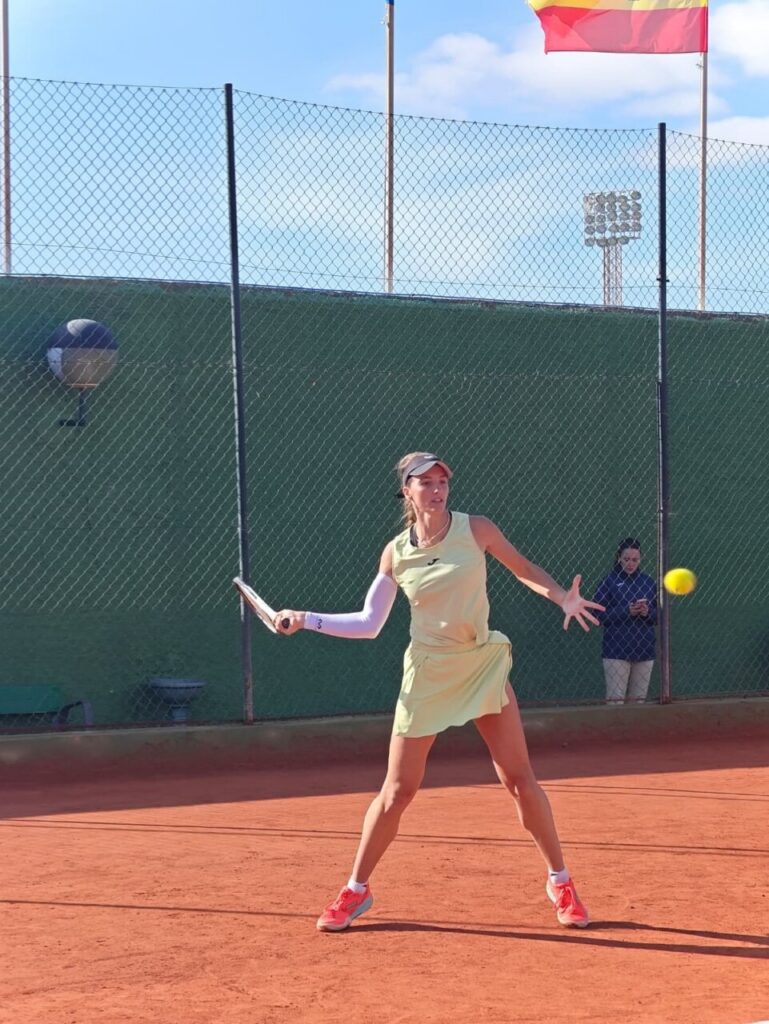 Jugadora de tenis en acción durante un torneo femenino.