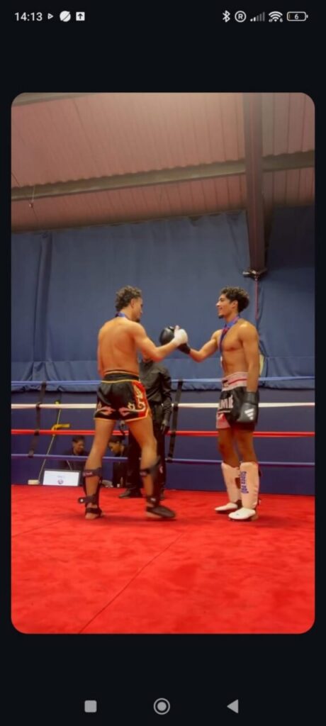 Dos competidores de kickboxing en el ring saludándose tras un combate