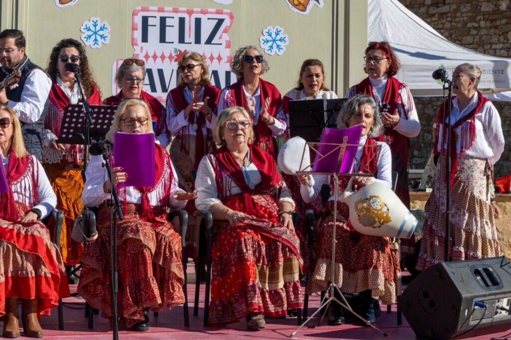 Mujeres cantando en un evento navideño con vestimenta tradicional