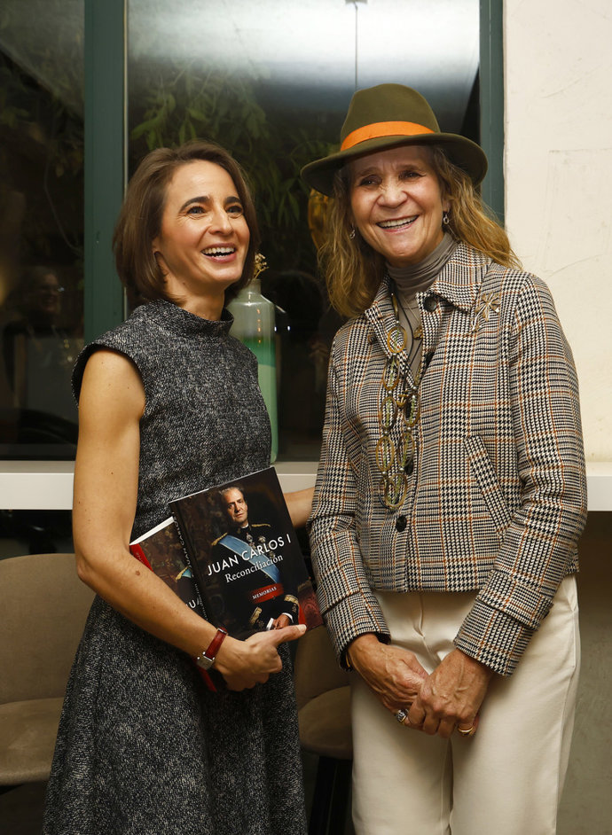 Dos mujeres sonrientes sosteniendo el libro de memorias de Juan Carlos I.
