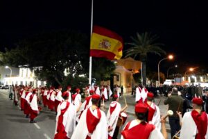 Ceremonia de arriado de bandera en Melilla con participantes en trajes tradicionales.