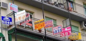 Viviendas en venta con carteles de anuncios en un balcón