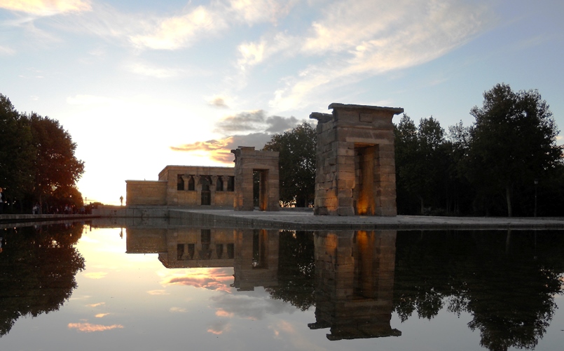 Templo de Debod en Madrid al atardecer reflejado en el agua.