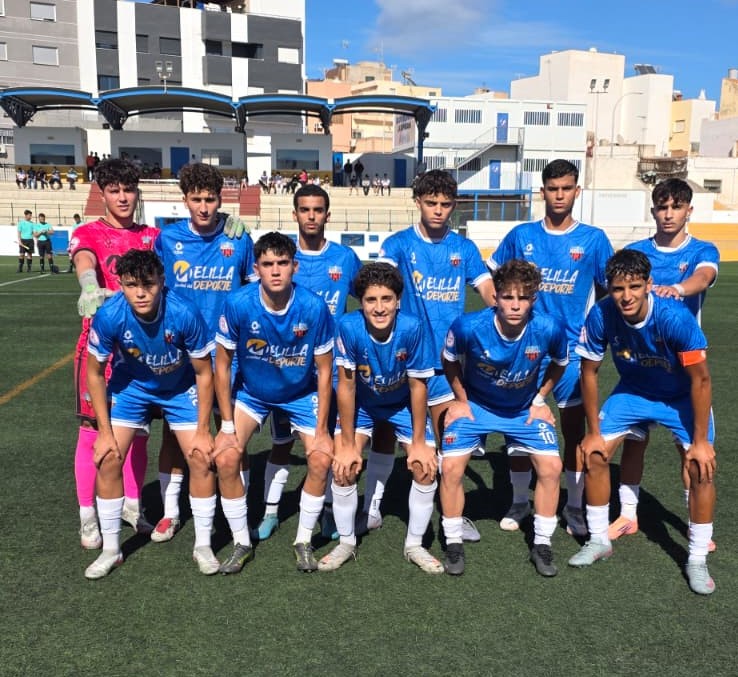 Equipo del C.F. Rusadir posando en el campo de fútbol