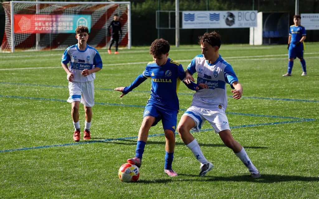 Jugadores de fútbol en un partido entre Melilla y Asturias