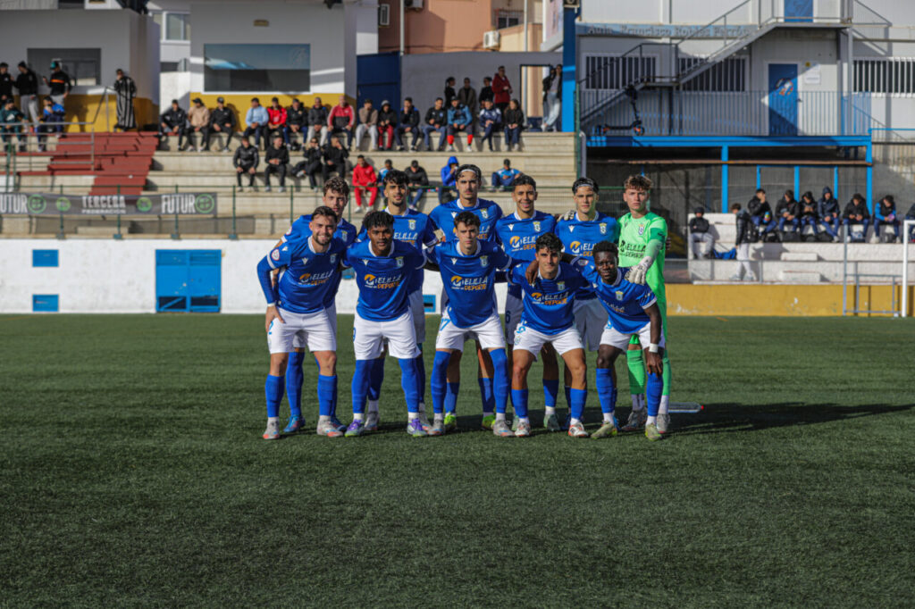 Jugadores del filial de la U.D. Melilla posando en el campo tras una victoria
