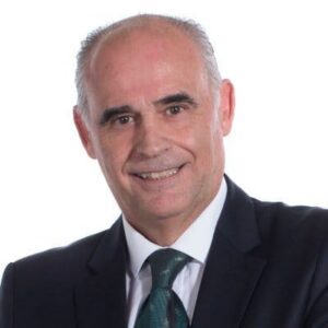 Retrato de un hombre de negocios con traje y corbata sonriendo.