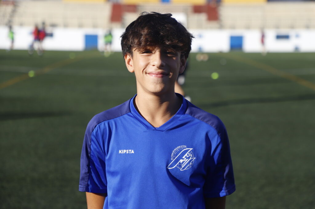 Joven futbolista melillense sonriente en campo de fútbol