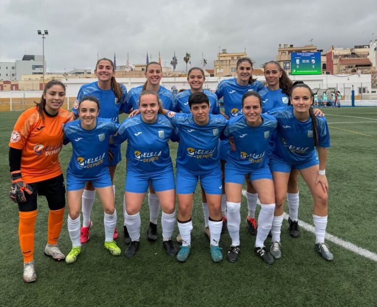 Equipo femenino de fútbol del ATM Melilla posando en el campo.