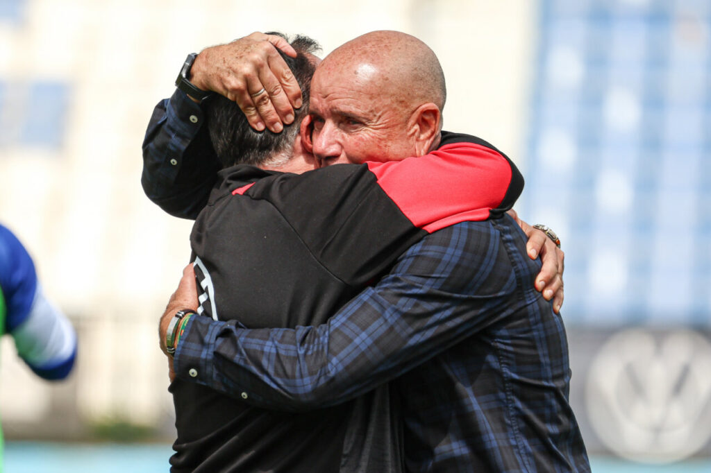 Entrenador Miguel Rivera abrazando a un compañero tras la victoria del equipo