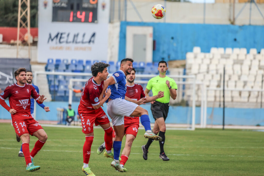 Jugadores de la U.D. Melilla y Club Atlético Antoniano en un partido de fútbol