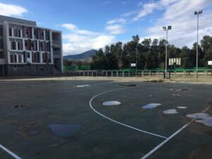 Cancha de baloncesto en Melilla con edificio escolar al fondo