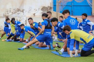 Jugadores de la U.D. Melilla realizando ejercicios de estiramiento en entrenamiento