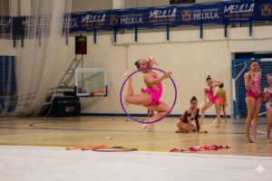 Gimnasta realizando un salto con aro en el Campeonato Ciudad de Melilla