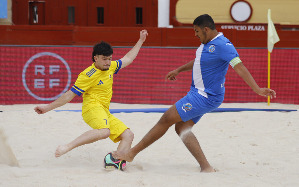 Jugadores de fútbol playa compitiendo en la arena durante un torneo