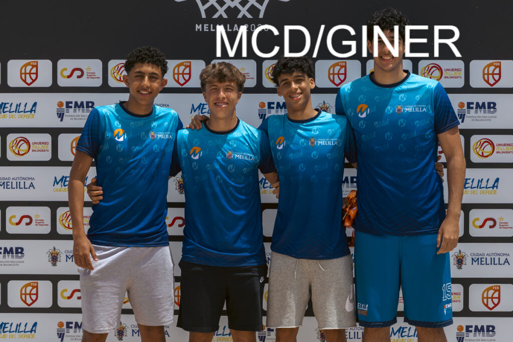 Four young men in matching blue jerseys pose with arms around each other in front of a sponsor backdrop at a sports event in Melilla.