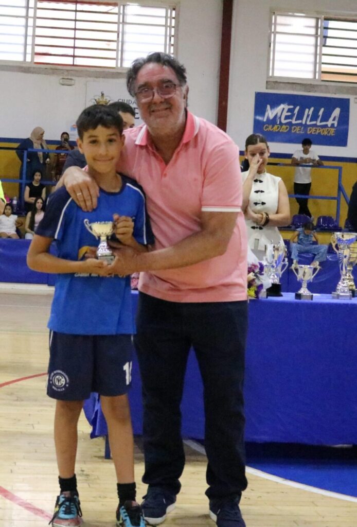 Niño recibiendo un trofeo en la clausura de la Liga Alevín de balonmano en Melilla