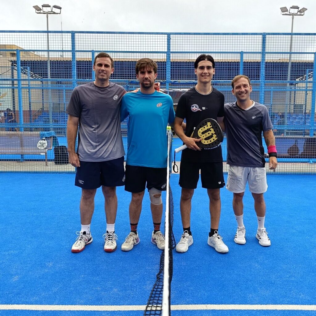 Cuatro jugadores posando en la cancha de pádel durante el torneo