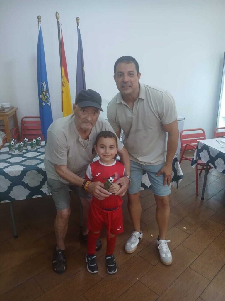 Tres personas posando en un evento de entrega de trofeos en la Escuela Luisca.