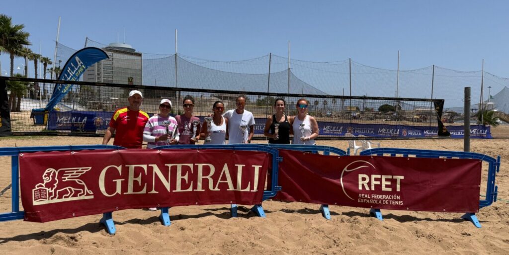 Eight players pose with trophies on a beach tennis court behind GENERALI and RFET banners, blue sky and net in the background.