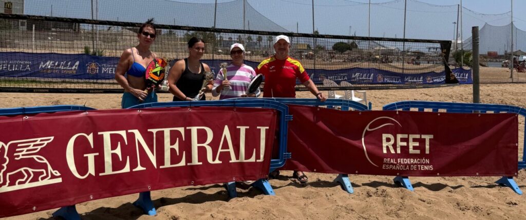 Group of four people on a beach tennis court posing with trophies behind a red Generali banner.