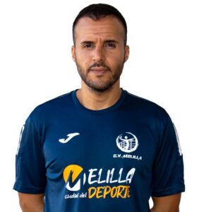 Portrait of a man wearing a blue sports jersey with Melilla logo, facing the camera.