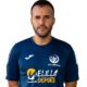 Portrait of a man wearing a blue sports jersey with Melilla logo, facing the camera.