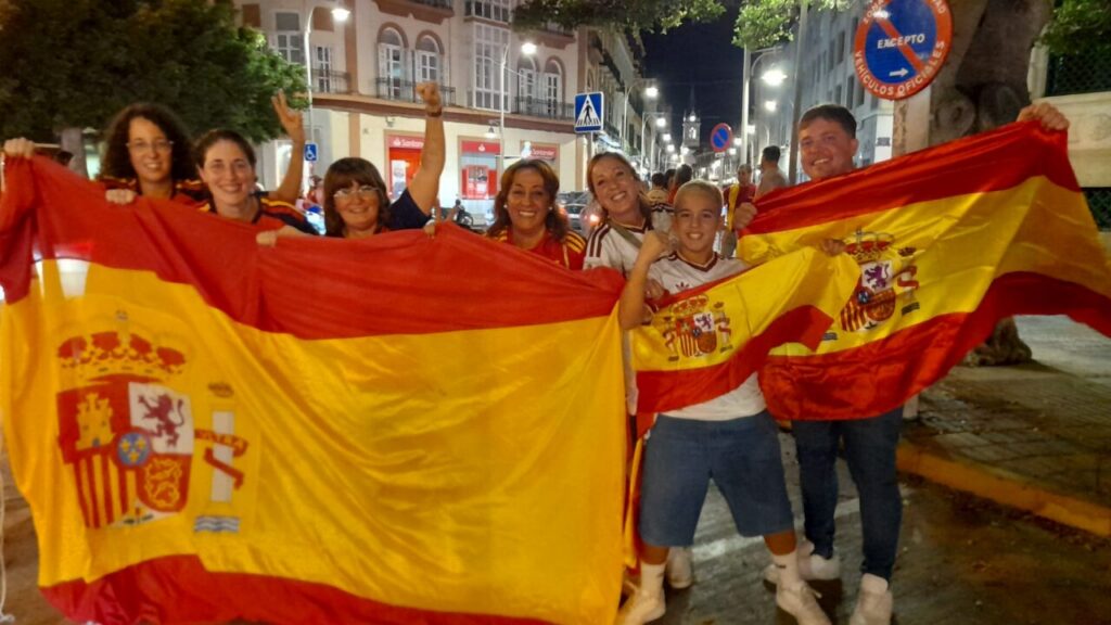 Grupo de personas celebrando con banderas de España en Melilla.