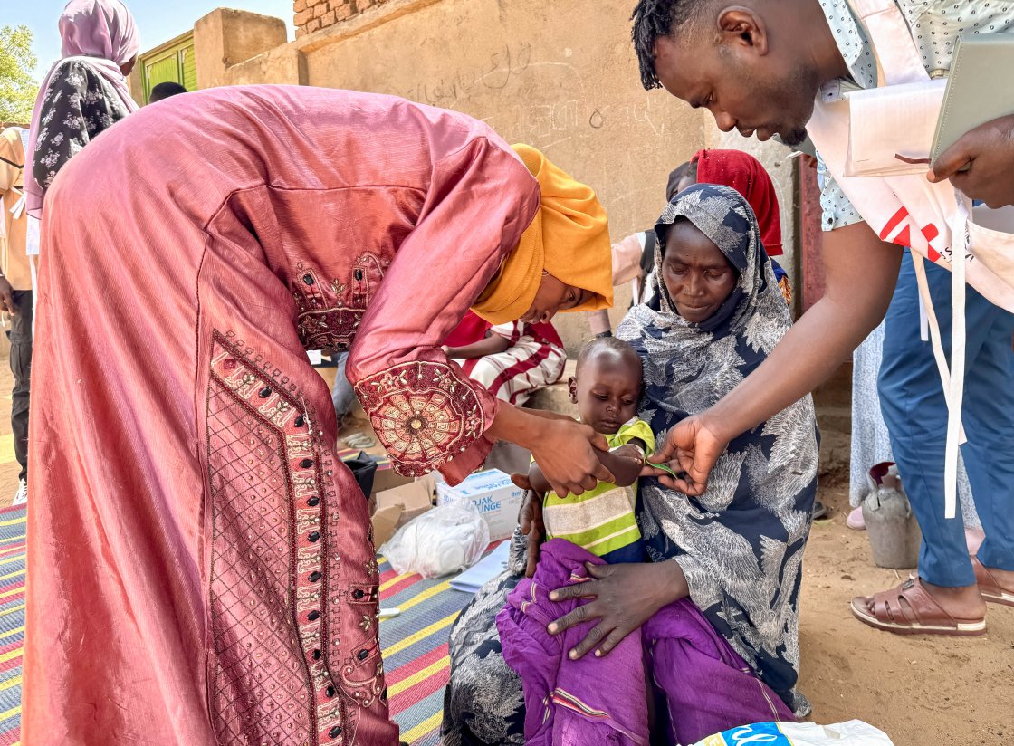 Mujeres y niños en un campamento de refugiados recibiendo atención médica