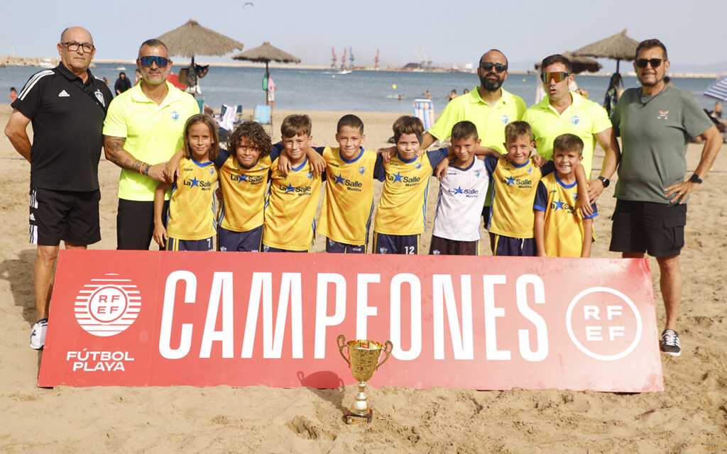 Equipo La Salle C celebrando su victoria en fútbol playa con trofeo