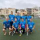 Equipo de Bomberos de Melilla posando en el campo de fútbol