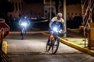 Ciclistas montando en la noche con luces brillantes en sus bicicletas