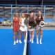 Cuatro mujeres posando con palas de pádel en una cancha