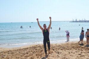 Nadador Miguel Ángel Rozas celebrando en la playa tras una competición.