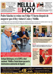 Front page of Melilla Hoy newspaper with a bold Pedro Sánchez headline; foreground photo shows two men at a cafe table with microphones, and smaller side images with captions.