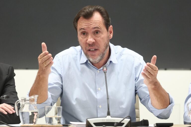 Óscar Puente habla ante un micrófono sentado a una mesa de reuniones.