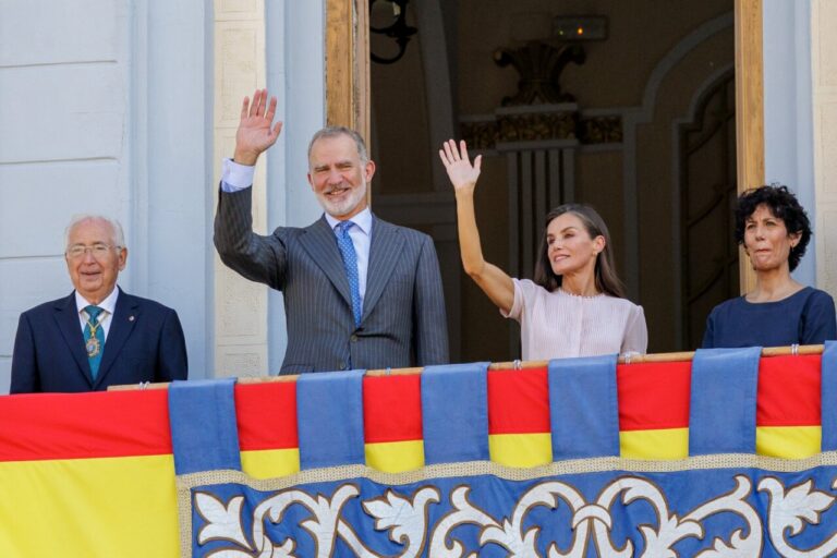Felipe VI y Letizia saludan desde un balcón junto a otras dos personas